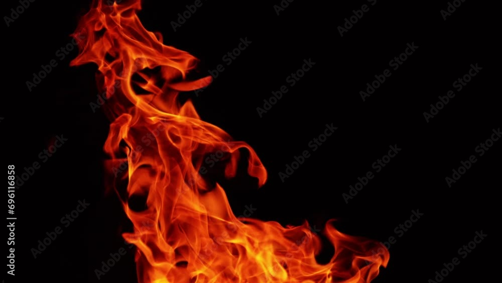 Dangerous flames of red hot fire rising into the air. Close up view of blaze in the darkness. Dangerous flames of red hot fire rising into the air. Close up view of blaze in the darkness.