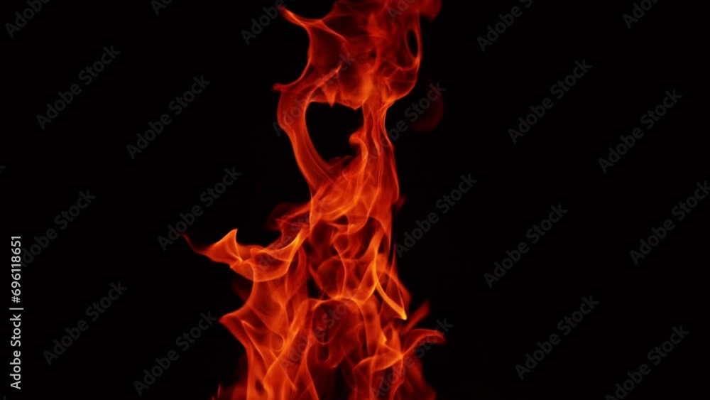 Red fire flame stretching high into the darkness. Blaze isolated at black backdrop. Red fire flame stretching high into the darkness. Blaze isolated at black backdrop.