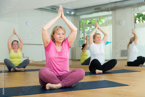 People studying new position at yoga modern school