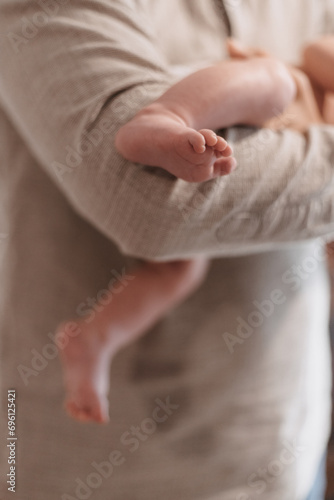 small child's foot in the arms of a parent
