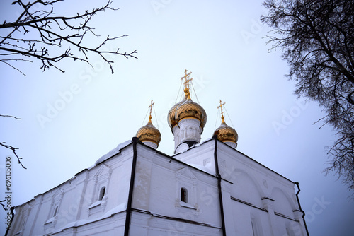 Golden domes with crosses of the Russian church against the sky photo