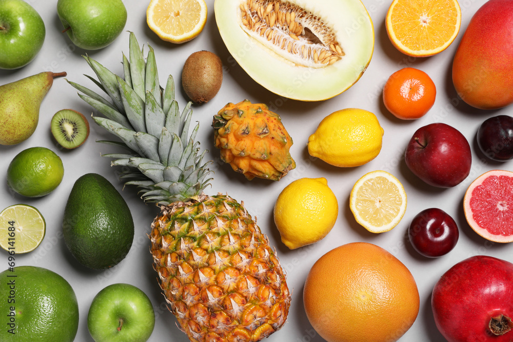 Many different fresh fruits on light grey table, flat lay Many different fresh fruits on light grey table, flat lay