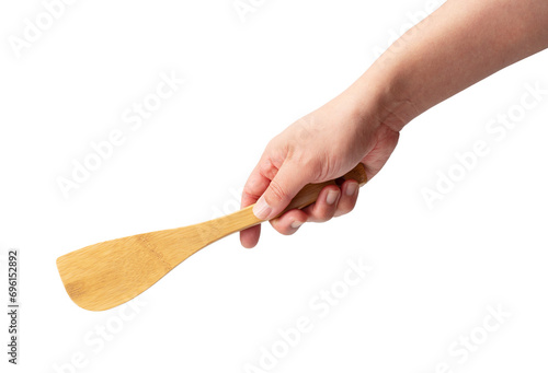 Wooden kitchen spatula in hand isolated on a white background. photo