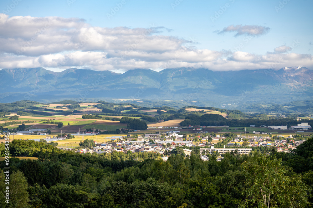 view across the valley that biei japan is nestled in towards the daisetsuzan national park