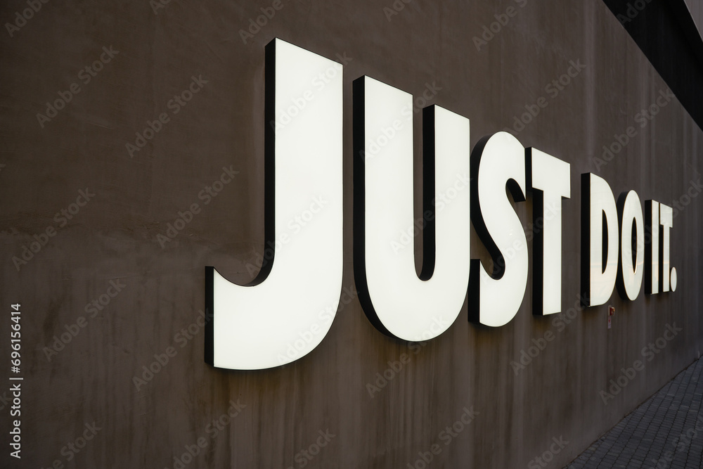 SHENZHEN CHINA NOVEMBER 22 2019 close up shot of Just Do It trademark of shoe company Nike as seen at UpperHills in Shenzhen. Stock Foto Adobe Stock