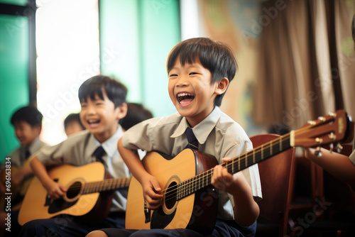 young children playing guitar in classroom