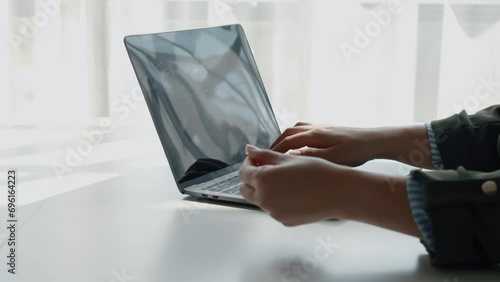 Person holding a credit card, she uses a credit card to pay for goods and services online, the concept of using a credit card for online shopping, ordering goods and services on the website. photo