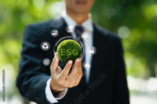 ESG icon for environment social governance investment business and ethical business concept. Green business investment strategy for sustainable. business hand holding green earth with