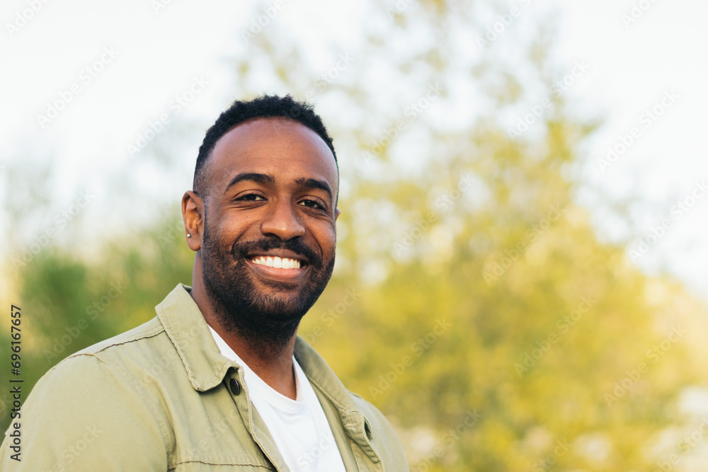 smiling afro american young man portrait in a park smiling afro american young man portrait in a park