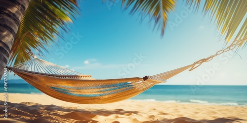 The beach hammock on a tropical beach, ready for a day of relaxation Golden sand meets the tranquil blue sea, creating a summer beach backdrop. © Nattadesh