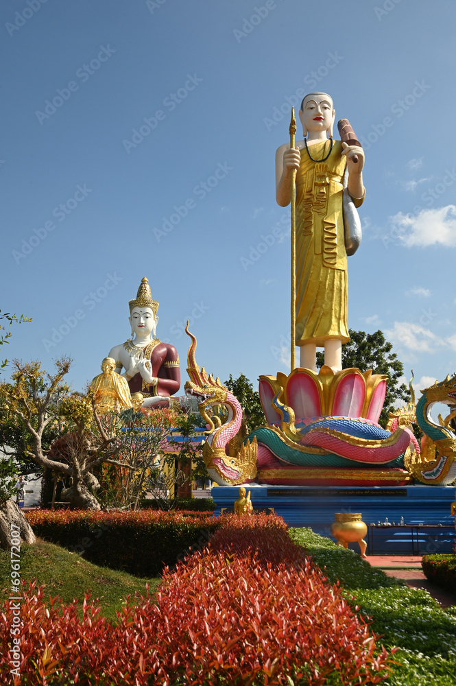 An outdoor statue of Phra Siwali is decorated for Buddhists to admire and there is a Phra Sri Ariyamettriya Borom Bodhiyan in the background at Wat Saeng Kaew Phothiyan temple. at Chiang Rai ,Thailand