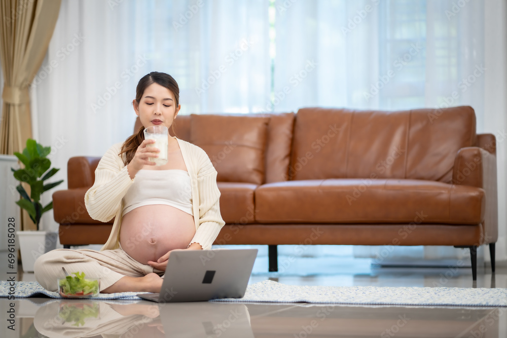 Pregnant woman drinking milk at home Pregnant woman drinking milk at home