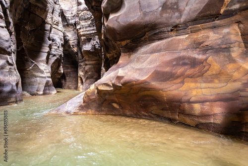 Bizarre  colors and patterns on the rocks along the Mujib River Canyon hiking trail in Wadi Al Mujib in Jordan photo