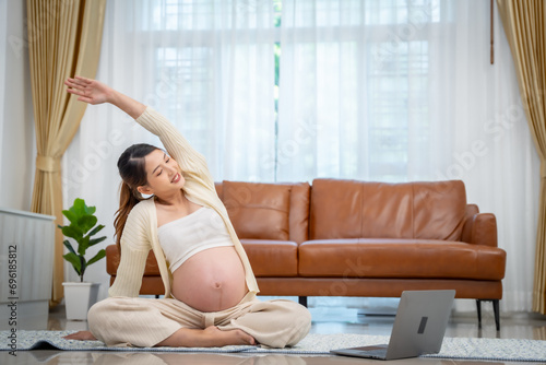 Pregnant woman doing exercise or yoga at home