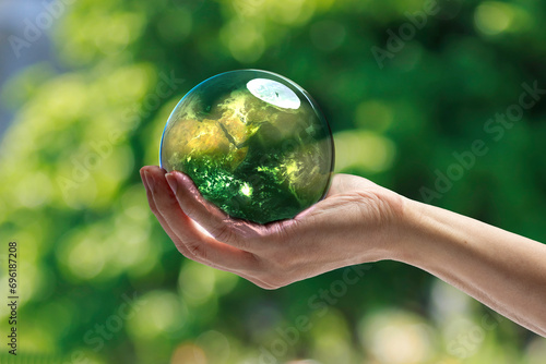 Energy saving concept Hand of human holding green world with environment icon, Save world, sustainable environment concept.