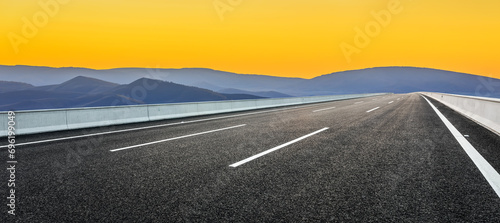 Asphalt highway road and mountain natural landscape at sunrise photo