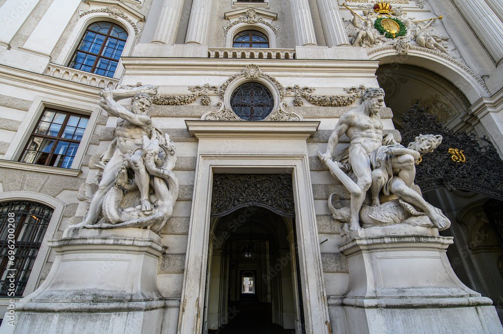 Baroque statues on the entrance gate of St. Michael's Wing of Hofburg Palace on Michaelerplatz in Vienna, Austria