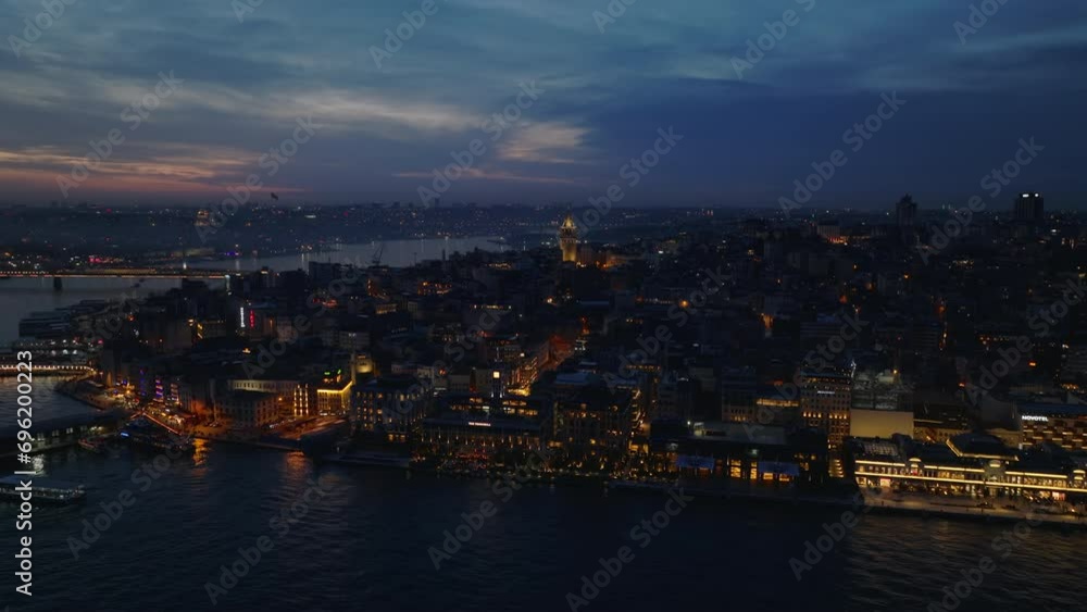 Forwards fly above night city. Buildings and streets at waterfront and urban borough in metropolis. Istanbul, Turkey Forwards fly above night city. Buildings and streets at waterfront and urban borough in metropolis. Istanbul, Turkey