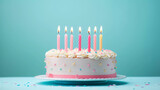 Birthday cake with 6 (six) candles on pastel blue background with copy space