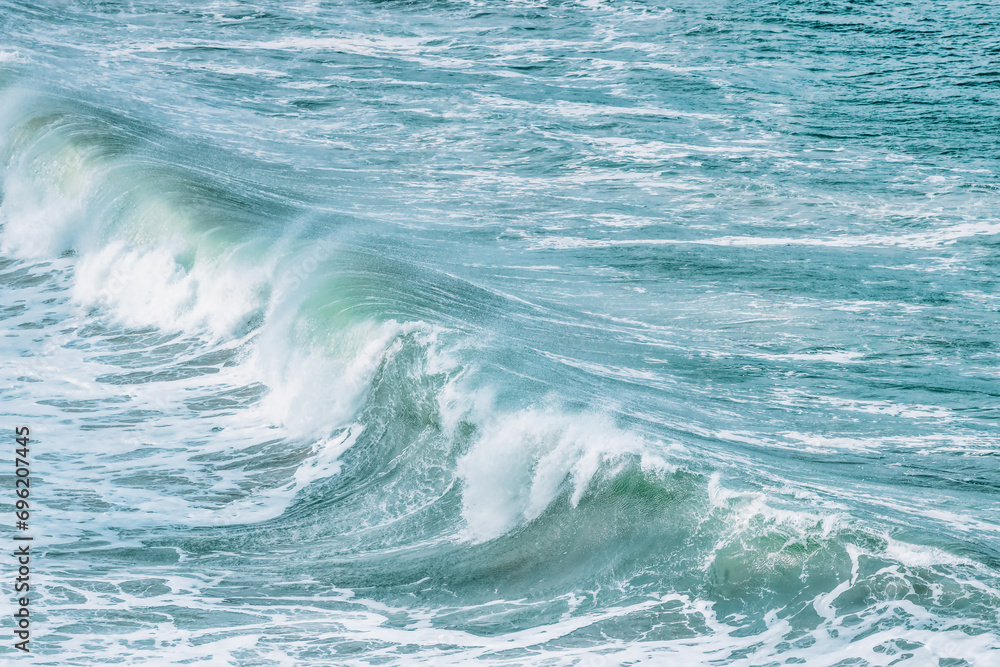 Obraz premium Wave splashing close-up. Crystal clear sea water, in the ocean in San Francisco Bay, blue water, pastel colors.