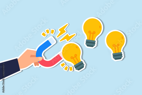 Imagination to create new ideas, creativity or innovation for new business concept, businessman hand holding magnet to magnetize or draw lightbulb lamp ideas.