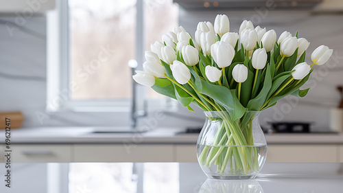 Spring tulips in a vase, stylish bright kitchen in the background