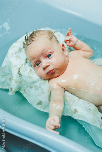 Wallpaper Mural Bathing a newborn in a bathtub. The first bath of a newborn baby. Torontodigital.ca