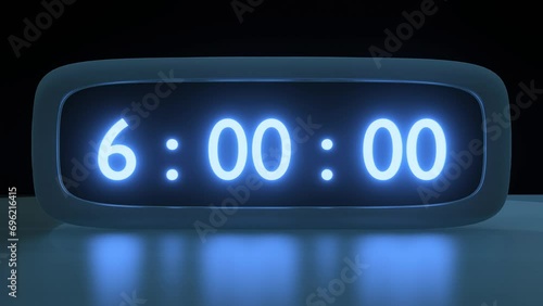 Digital alarm clock with blue clockface waking up at 6 AM. The numbers on the clock screen changes from 5:55 to 6:00 AM. Close up view. Digital Red Alarm Clock Timekeeper photo
