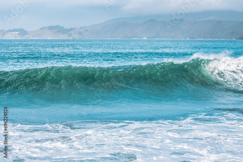 Wave splashing close-up. Crystal clear sea water, in the ocean in San Francisco Bay, blue water, pastel colors.