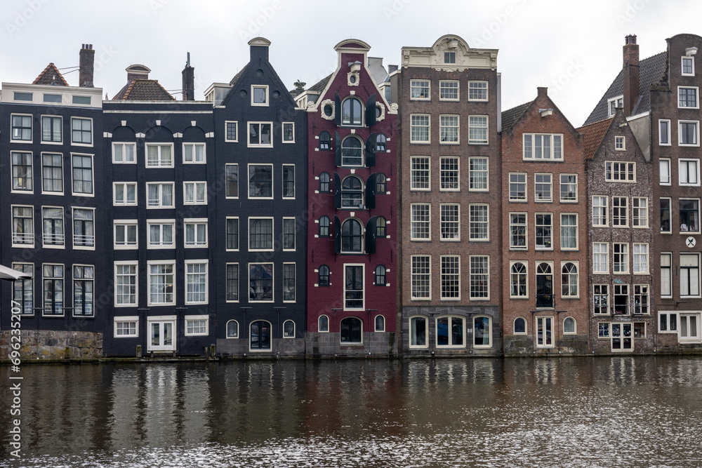  Typical gabled houses on Damrak district in  Amsterdam, Netherlands