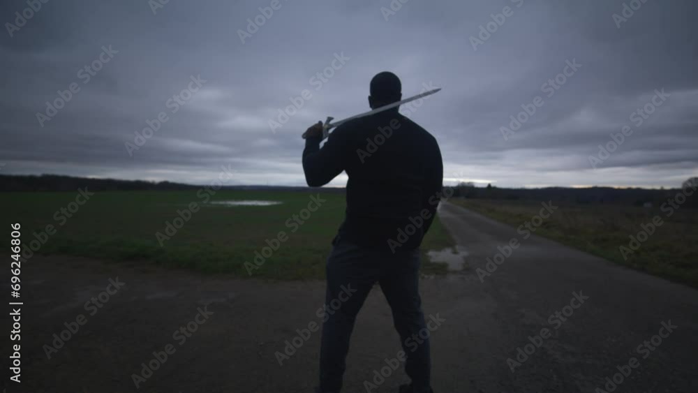 Modern Black Swordsman Warrior Awaiting Battle Opponent in Open Field Under Grey Sky, Europe, 4K | Muscular, Intimidating, Shadow, Figure, Blurry, Dark Clothes, Powerful, Guarding, Searching Modern Black Swordsman Warrior Awaiting Battle Opponent in Open Field Under Grey Sky, Europe, 4K | Muscular, Intimidating, Shadow, Figure, Blurry, Dark Clothes, Powerful, Guarding, Searching
