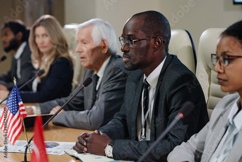 Group of business people giving an interview to journalists during conference