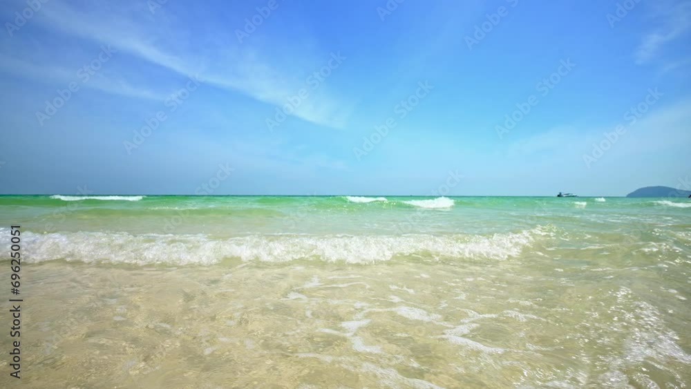 Slow Motion of Foamy Waves Rolling Towards Sand Beach. Crashing Waves Hitting a Tropical Beach Sunny Day. Dream Vacation