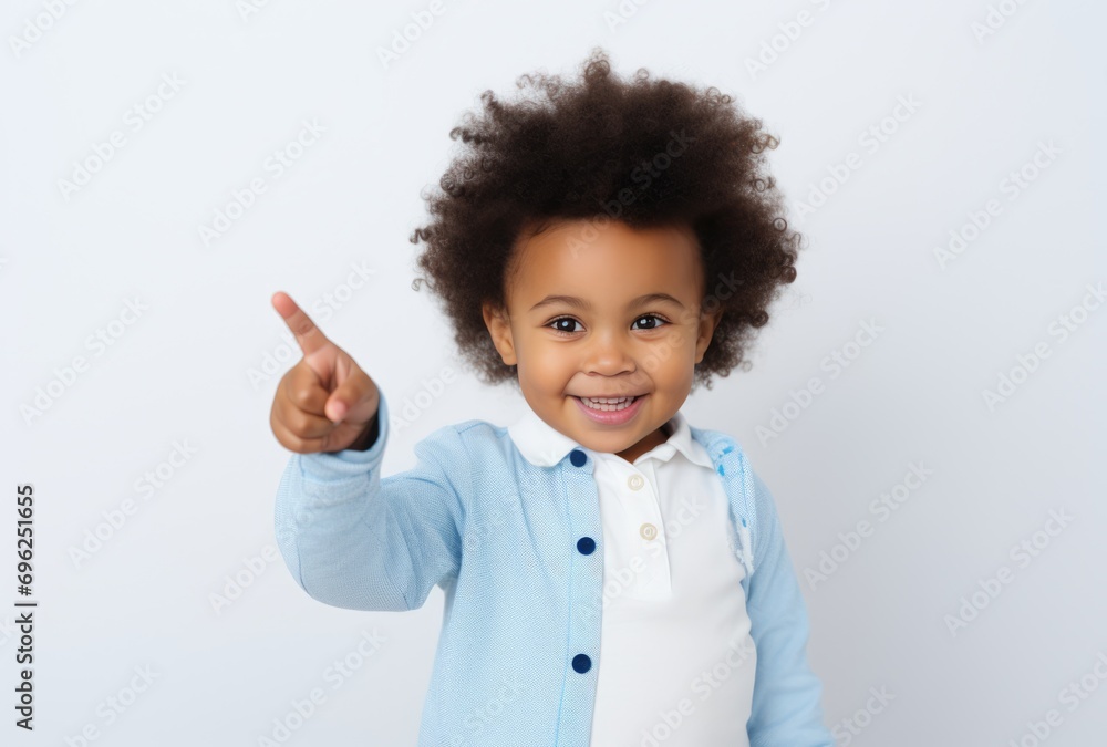 Adorable little girl with curly hair pointing at something Adorable little girl with curly hair pointing at something