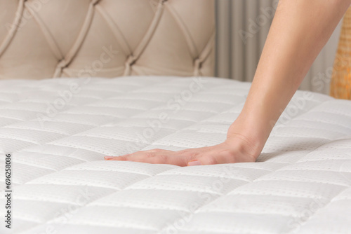 Принти на полотні Woman press on comfortable mattress, checking and testing quality