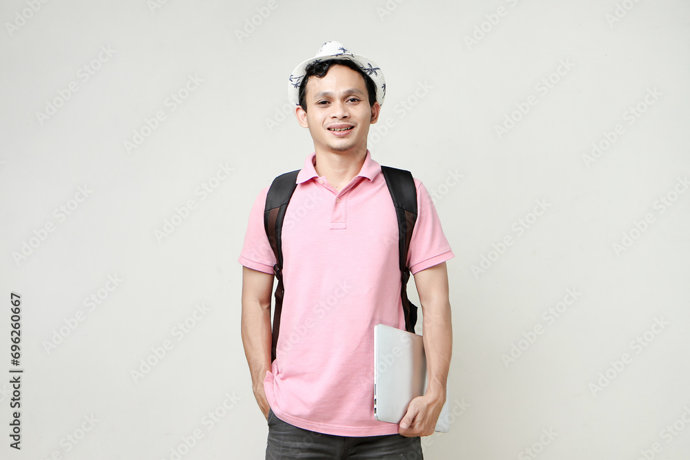 Asian man backpacker holding laptop computer. digital nomad and travelling concept. on isolated background Asian man backpacker holding laptop computer. digital nomad and travelling concept. on isolated background