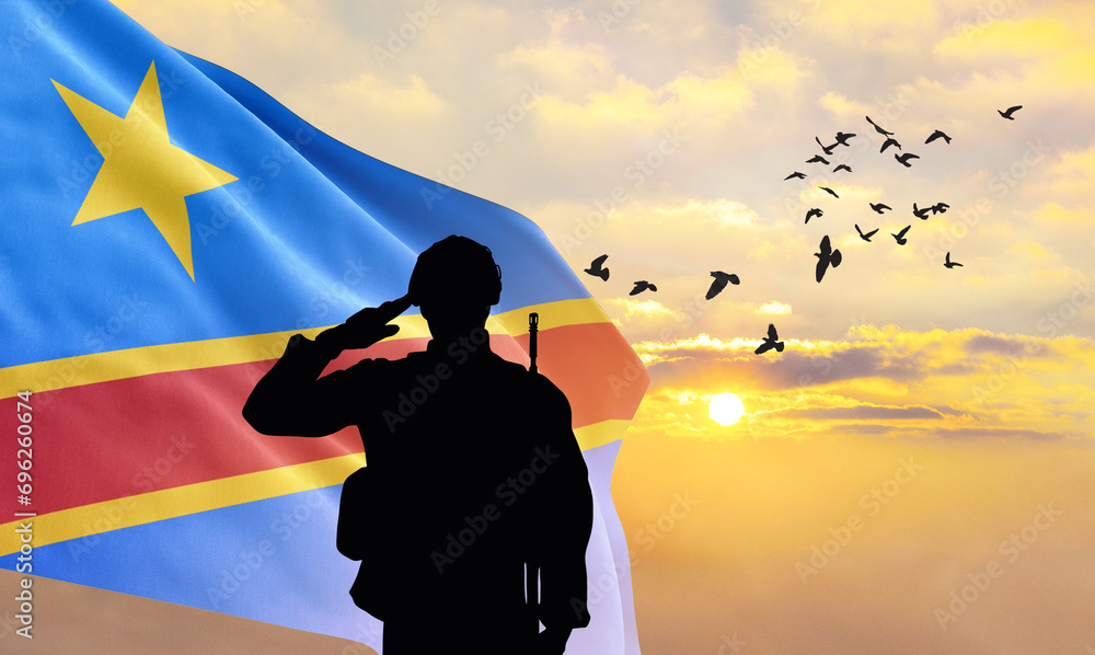 Φωτογραφία Silhouette of a soldier with the DR Congo flag stands against the background of a sunset or sunrise