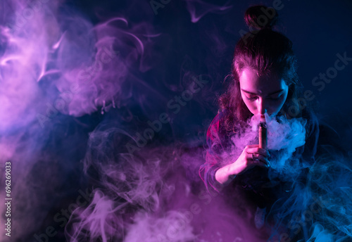Woman vaper. Girl using vap...