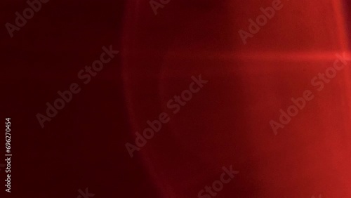Red light leak lens flare on black background photo