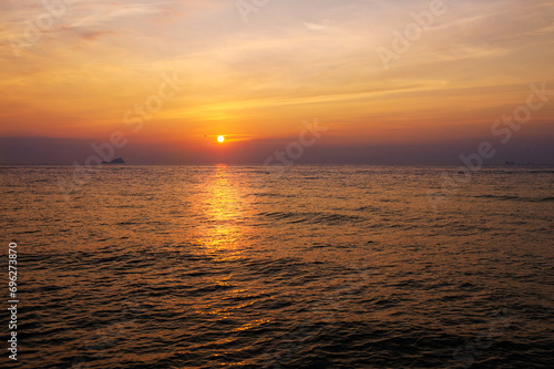 Beautiful sunset landscape with dramatic sky, sun and sea water