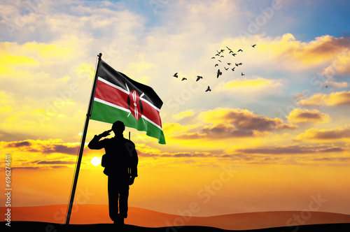 Silhouette of a soldier with the Kenya flag stands against the background of a sunset or sunrise. Concept of national holidays. Commemoration Day.