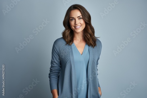 A woman wearing a blue sweater and smiling for the camera A fictional character created by Generated AI. 
