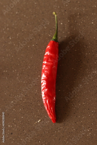 A big Indian red Chilly on the marble floor selective focus