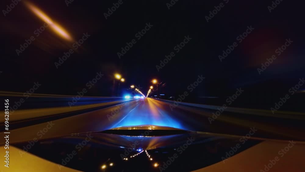 Speedy Car Driving on a Highway With a Lot of Lights and Traffic. City Road and Glittering Streets and Buildings All Turning Into Colorful Light Trails Speedy Car Driving on a Highway With a Lot of Lights and Traffic. City Road and Glittering Streets and Buildings All Turning Into Colorful Light Trails