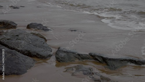Wallpaper Mural Normandy, France. 11-01-2023. Super close up sea waves breaks on rocks in shore. Omaha coast. Super slow motion 4K Torontodigital.ca