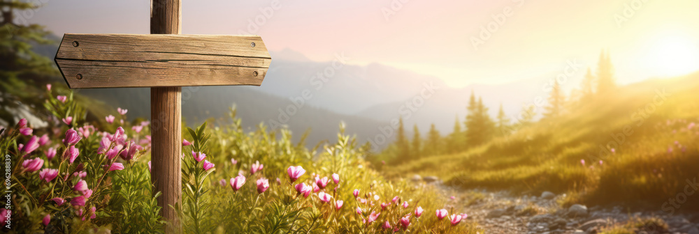 Wooden signpost mock up on a mountain trail among pink wildflowers at golden hour - obrazy, fototapety, plakaty 