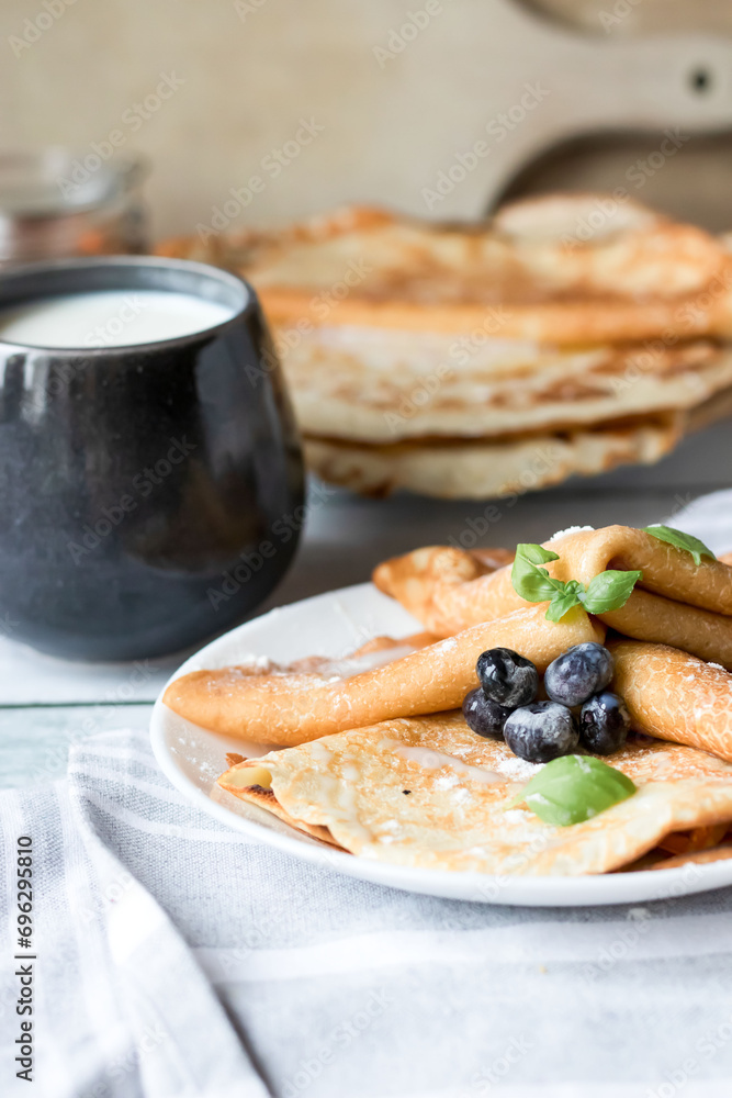 Breakfast: fresh pancakes with berries. On a wooden background. Morning