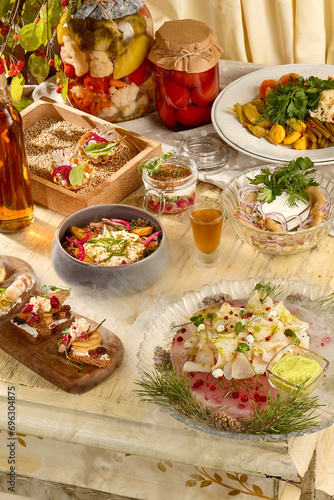 Assortment of Slavic appetizers: stroganina, pickled mushrooms, and various pickles in a rustic setting