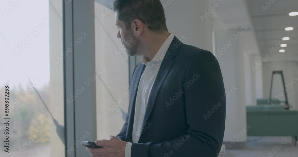 Corporate Businessman in Modern Office Using Smart phone Corporate Businessman in Modern Office Using Smart phone