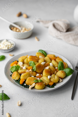 	
Fried Italian potato gnocchi with cheese and herbs on a white background. Italian food.